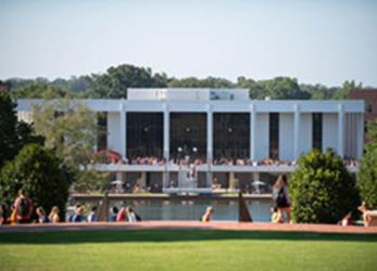 students lounging outside modern university building